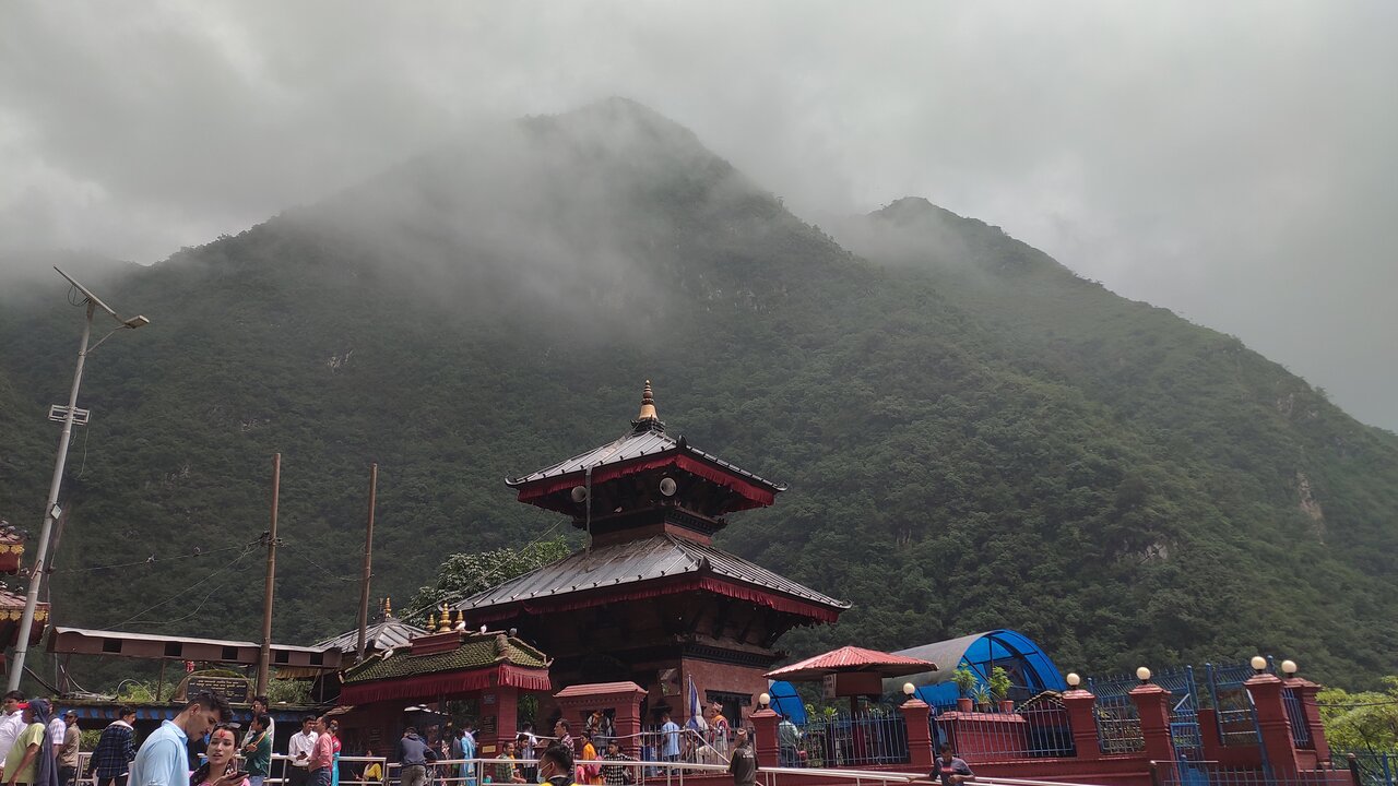 Aerial view of Supa Deurali Temple complex showing cliff-side location and surrounding forest landscape